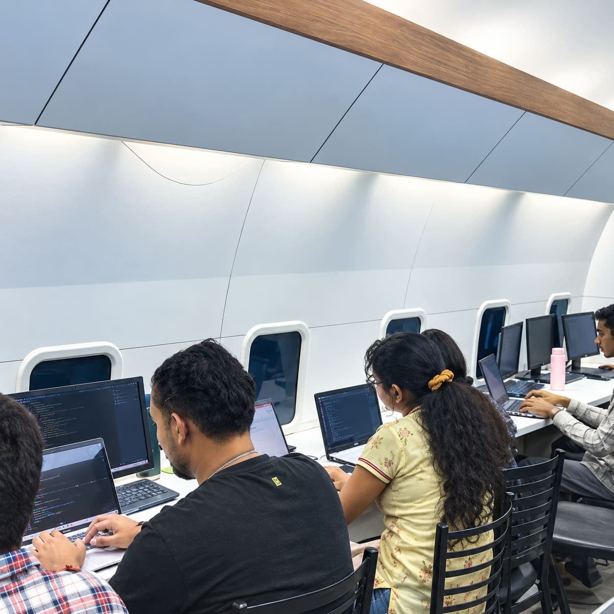 Interns coding in the TechCADD aircraft-style lab