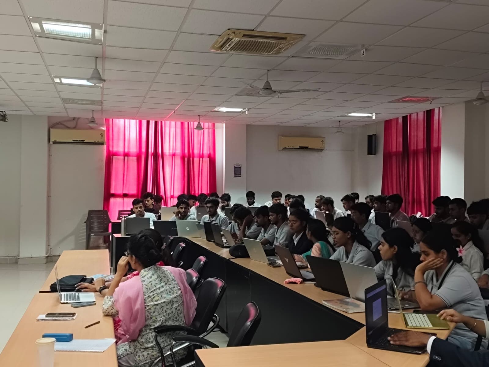 Students building AI agents on their own laptops at a techcadd workshop